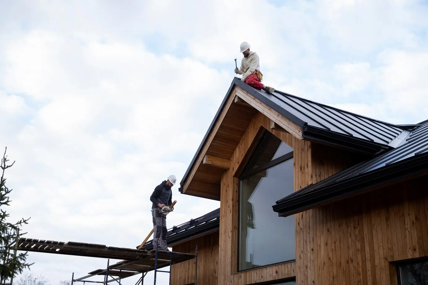 Long shot of men working on a roof.